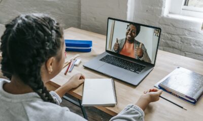 Ethnic girl having video chat with teacher online on laptop